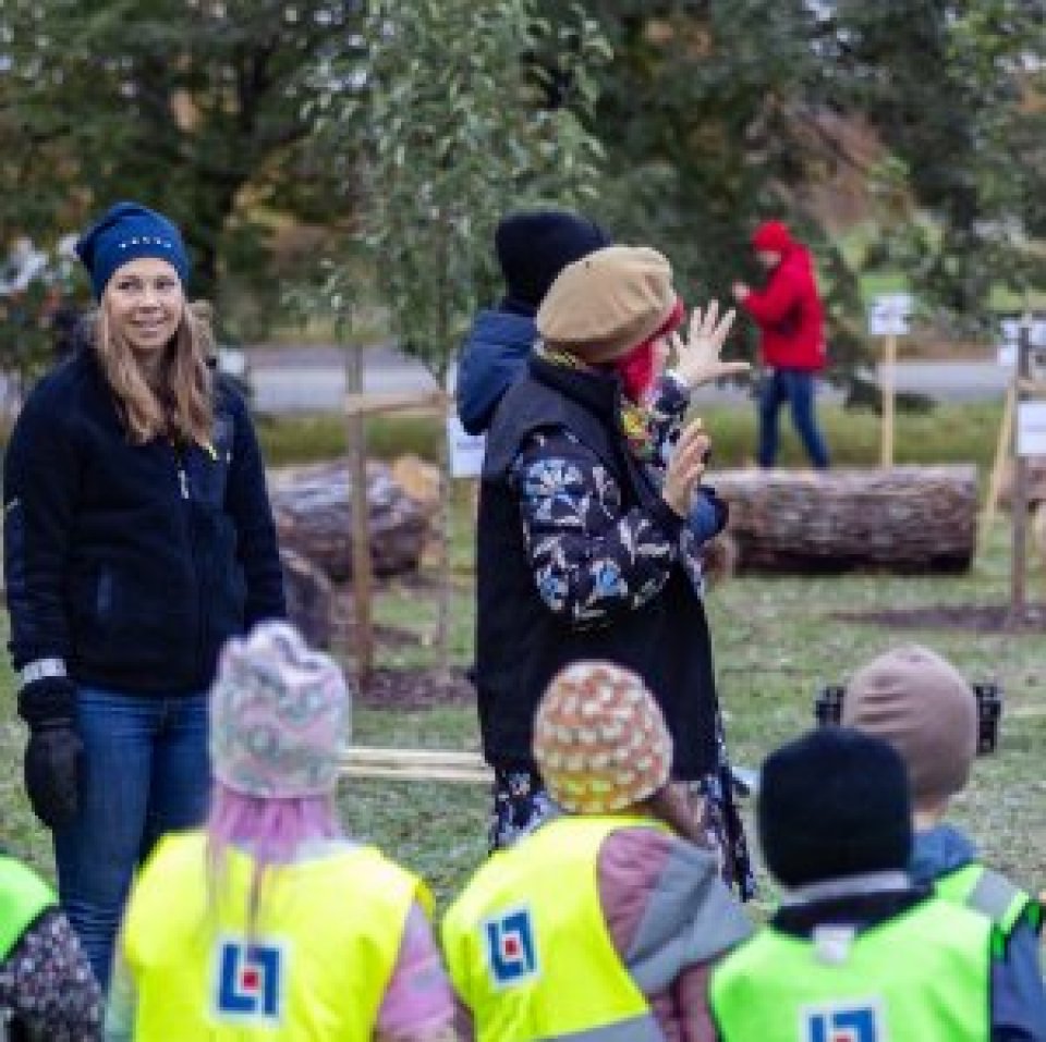 Adults and a group of children outdoors