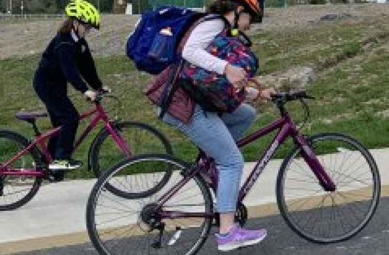 Two people cycling on a cycleway