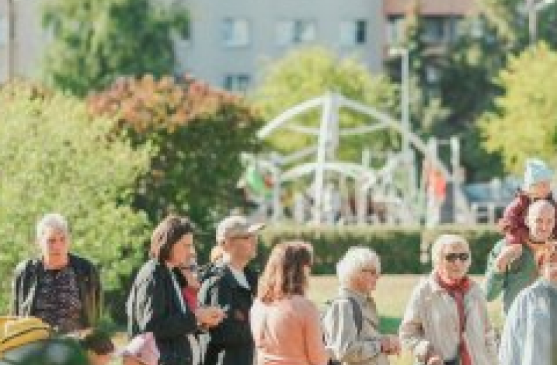 Group of people outside near a playground