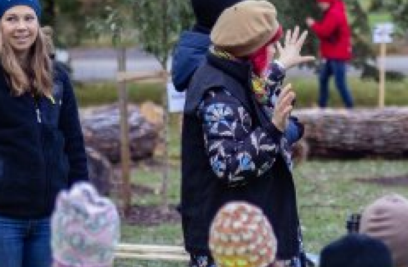 Adults and a group of children outdoors