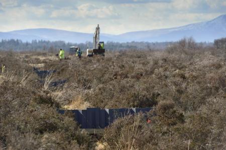Peatland rewetting with tractor in the backgrounf