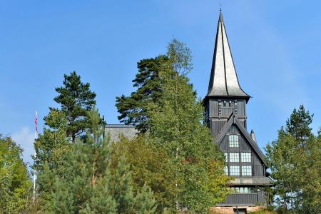 Dark spire with trees in the foreground. 