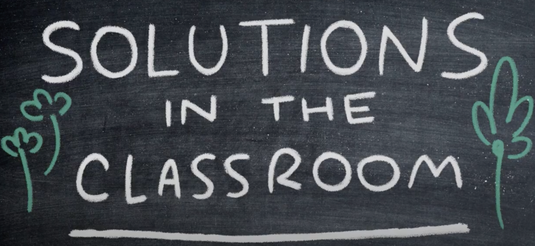 solutions in the classroom written on chalkboard