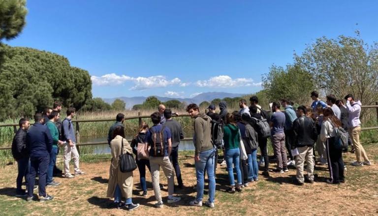 A large group of people stood looking at a river in Granollers.