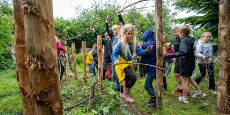 A group of children collecting sticks.